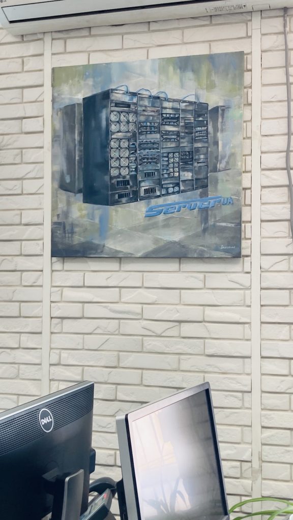 A painting with server racks hanging on the office wall.