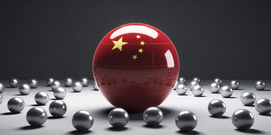 A large red sphere with the Chinese flag among smaller silver spheres.